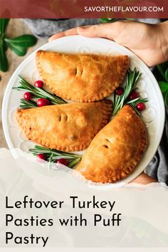 leftover turkey pasties with puff pastry on a white plate, topped with rosemary sprigs