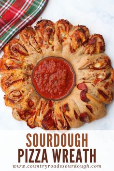 this is an image of a pizza with sauce on it and the words, sourdough pizza wreath