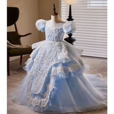 Indulge your young princess in this floor length organza dress. Perfect for special occasions such as baptisms, weddings, and holiday celebrations. Featuring a crossed strap back, lace and beaded embellishments, and a round neckline with puff sleeves. This blue dress is the epitome of elegance and grace. Organza Flower Girl Dress, Girls Birthday Party Dress, Crinoline Skirt, Toddler Party Dress, Organza Flowers, Organza Dress, Girl Princess Dress, Birthday Party Dress