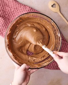 someone is mixing chocolate in a bowl with a spoon