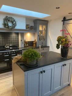 a kitchen with an island, sink and stove in it's centerpieces