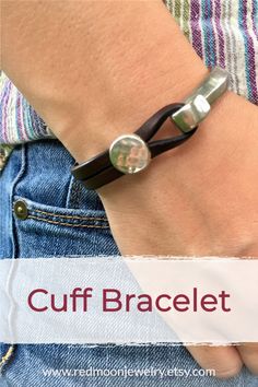 a close up of a person's arm wearing a bracelet with the words cuff bracelet on it