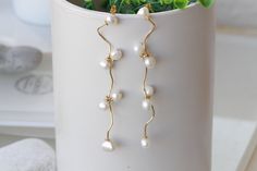 PEARL DANGLE EARRINGS, Freshwater Pearls Chandeliers, Ivory Pearl Minimalist Earrings, Wedding Pearl Earrings, Dainty Long Bridal Earrings Details of item: Metal: Brass - nickel free Plating Finish: 24K Gold Plated - Nickel Free Gemstone: freshwater pearls Earrings Size: 4 inches long The earrings will be packed in a gift box. FOR MY EARRINGS COLLECTION HERE: https://www.etsy.com/il-en/shop/rebekajewelry?section_id=14222612&ref=shopsection_leftnav_3 TO GET TO MY ETSY SHOP: https://www.etsy.c Dainty White Pearl Drop Chandelier Earrings, Cream Dangle Jewelry For Wedding, Elegant White Chandelier Earrings, White Pearl Linear Earrings For Formal Occasions, White Long Drop Chandelier Earrings For Wedding, Elegant White Pearl Linear Earrings, Graceful White Dangle Bridal Earrings, White Long Drop Bridal Earrings For Wedding, Graceful White Pearl Bridal Earrings