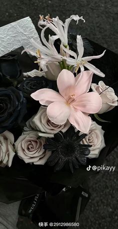 a bouquet of flowers sitting on top of a black table