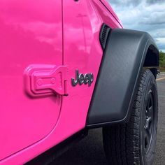 a pink jeep with the word jeep painted on it's side