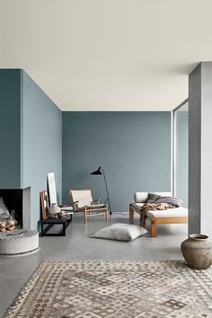 a living room with blue walls and furniture