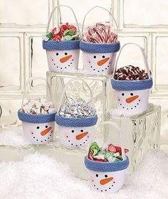 a snowman themed ice bucket filled with candy and candies