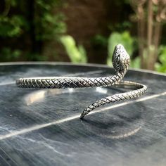 Handcrafted Solid Sterling Silver .925/ Snake Bangle Cuff Bracelet 100% hand-polished solid sterling silver Inside bracelet diameter 5.7cm/ 2.24 inches Approximate weight 13.8 grams Magnificent snake cuff bracelet crafted in solid 925 sterling silver. The bracelet come with a 925 stamp on the inside. Amazing crafted looking snake forming a circle with its body is beautifully detailed throughout the piece. Snake symbolize fertility or a creative life force. As snakes shed their skin through sloug Silver Snake-shaped Bracelet As Gift, Silver Snake-shaped Bracelets For Gifts, Silver Snake-shaped Bracelet For Gift, Silver Snake Shape Bracelet As Gift, Silver Snake Bracelet As Gift, Silver Snake Bracelet Gift, Silver Snake Bracelet For Gift, Adjustable Silver Sterling Silver Bangle, Adjustable Silver Cuff Bracelet With Oxidized Finish