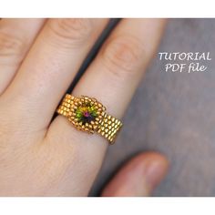 a woman's hand with a ring on it that has a flower in the middle