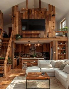 a living room filled with furniture and a flat screen tv mounted to the side of a wooden wall