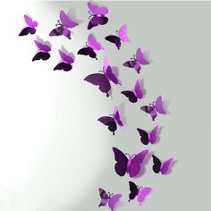 a group of purple butterflies flying in the air