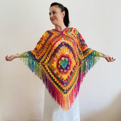 Rainbow plus size poncho women unisex poncho men crochet granny square poncho fringe festival vegan poncho geometric poncho cape coat Handmade One Size Poncho For Festivals, Hippie Poncho With Tassels One Size, Hippie Shawl Poncho For Festivals, Handmade Bohemian Poncho For Festival, Hippie Tassel Poncho One Size, Bohemian Colorful Poncho For Festival, Oversized Bohemian Cape For Festivals, Handmade Shawl Cape For Festival, Handmade Winter Festival Cape