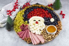 a platter filled with fruit, crackers and nuts