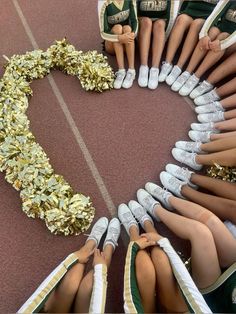 a group of cheerleaders sitting in a circle with their hands on their hips