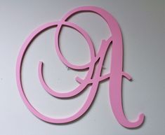 a pink monogrammed wall hanging with the letter g in it's center