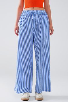 Add a touch of class and comfort to your wardrobe with these stylish Blue Striped Pants, featuring vertical white stripes for a classic yet contemporary look. Designed with comfort and versatility in mind, these pants are a perfect choice for any season.  Crafted from lightweight woven fabric made of 100% polyester, these pants offer a comfortable and breathable feel that's suitable for daily wear. The high waist rise and straight leg silhouette create a flattering fit, while the elastic waist ensures comfort and ease of movement.  Featuring a drawstring closure and side pockets, these pants combine practicality with fashion-forward design. The addition of "love amour passion" written in pink on one pocket adds a playful and romantic touch to the design.  Our model, standing at 5'10'' with Blue Striped Pants, Blue Pants Outfit, Tan Scarf, Pants With Elastic Waist, Scarf Headband, Trouser Pants Women, Blue Pants, Basic Tops, Romper Pants