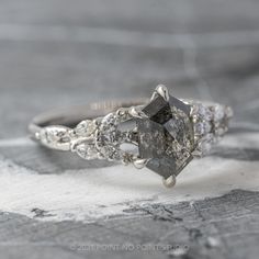 a close up view of an engagement ring with diamonds on the side and in the middle