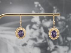 Sophisticated and yet interesting, these earrings feature bright bursts of color from the amethysts and an excellent shine from every facet. The perfect size to transition from day to evening, these lovely earrings are sure to be a favorite of your jewelry wardrobe. Metal: 14K Yellow Gold Gem: 2 Amethyst Gem Measurements: 9.8 x 7.7 mm, Oval Earrings Length: 34 mm Earrings Width: 15 mm Marks: “14K” Stamped on the Findings Purple Oval Fine Jewelry Earrings, Formal Amethyst Drop Earrings, Elegant Oval Amethyst Earrings, Oval Amethyst Earrings With Gemstone Accents, Round Purple Earrings With Gemstone Accents, Purple Gemstone Accented Round Earrings, Purple Round Earrings With Gemstone Accents, Purple Oval Earrings With Gemstone Accents, Purple Gemstone Accent Round Earrings