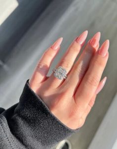 a woman's hand with a diamond ring on it