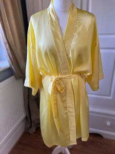 This beautiful sun yellow silk bathrobe/ dressing gown is perfect for you and your bridesmaids/ bridesmen to wear whilst getting ready for your special day. Or it can be given as a special gift for a Birthday, Mother's Day or any other special occasion.  It is made in three sizes,  UK 8-16, UK 20-24 and UK 26-30. The plus size gowns can take 2-3 weeks for delivery.     It can also be made in smaller children's sizes to fit your flower girls too -please message us for details. It can be personali Yellow Pajamas, Silk Bathrobe, Floral Gown Dress, Satin Dressing Gown, Silk Dressing Gown, Gown Elegant, Plus Size Gowns, Satin Sleepwear, Sun Yellow