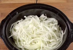 onions are being cooked in the slow cooker