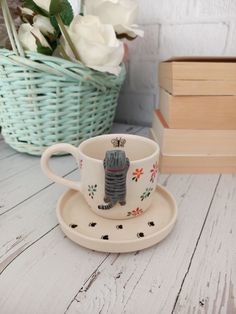 a cup and saucer with a small elephant on it