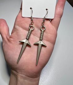 Naruto Shippuden anime-inspired earrings with a silver pendant of Minato Namikaze's kunai, the Flying Raijin, on a nickel-free hook.  comes with a couple Naruto stickers  Gift wrap option available - item wrapped in tissue inside a box tied with ribbon - add at checkout.  Made in Eugene, OR Zhongli Earring, Kurapika Earring, Anime Jewelry Earrings, Kunai Earring, Scythe Earrings, Naruto Shippuden Anime, Anime Inspired, Gift Stickers, Naruto Shippuden