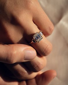 a person's hand with a ring on it