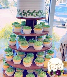 cupcakes are arranged in the shape of a tower with green frosting on top