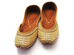 Ethnic Indian/Pakistani style shoes durable and hand stitched with genuine leather sole and leather padded cushion inside. The color of the shoe consists of beautiful yellow base with gold embroidery work with a pearl embroidery with descent sequence lined to fit the combination of this perfect shoe! Gift for a friend, gift for a bride, or gift for yourself. These shoes are perfect for any special occasions or for the day-to-day outfits. One of our popular shoes for weddings, and formal events. These shoes are sure to make you beautiful with every outfit you try them on with! See our page for more of our collection! We ship out in a timely matter, wrapped in care for a safe secure trip to your location. Thank you for supporting our small business! Shipped from USA. Sizes available US 6,7,8 Embroidered Leather Flats With Flat Heel, Leather Embroidered Flats, Embroidered Leather Slip-on Flats, Festive Handwork Leather Flats, Traditional Round Toe Flats For Festivals, Festive Leather Flats With Handwork, Festive Embroidered Leather Flats, Handwork Round Toe Festival Flats, Handwork Round Toe Flats For Festival