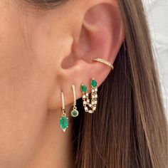 Pave Diamond & Emerald Drop Huggie Pierced Earrings 14K Yellow Gold 0.07 Pave Diamond Carat Weight 0.13 Emerald Carat Weight 0.65 Inches Long 0.43 Inch Diameter Ear Piercings Emerald, Green Earring Stacks, Emerald Ear Stack, Double Piercing Chain Earrings, Emerald Earring Stack, Green And Gold Earring Stack, Gold And Emerald Earrings, Gold And Emerald Jewelry, Emerald Piercing