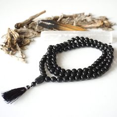 Purify your energy and ground when you meditate with this mala necklace! Known as a supreme purifying stone, each smooth black tourmaline beads helps you resonate with your base chakra while focusing your mind. The raw black tourmaline guru bead helps bring a less more rustic vibe to your practice. You personalize the Black Tourmaline Necklace, Raw Black Tourmaline, Base Chakra, Raw Crystal Jewelry, Beaded Tassel Necklace, Aquamarine Necklace, Tourmaline Necklace, Tourmaline Beads, Crystal Meanings