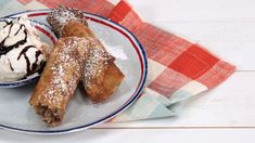 two pastries on a plate with ice cream