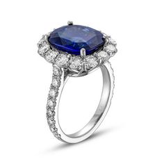 an oval shaped blue sapphire and diamond ring with shoulders set in 18k white gold