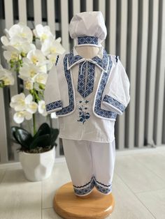 Discover our beautiful traditional blue Romanian costume for little children, an outfit that captures the essence and elegance of Romanian folklore. This costume is meticulously crafted with high-quality fabrics to ensure comfort and durability, while honoring artisan traditions. The white shirt is adorned with delicate embroidery, handmade with bright blue threads, depicting traditional designs that tell a story of heritage and culture. The matching pants, also decorated with embroidered detail Embroidered Outfit, Cotton Outfit, Embroidered Clothes, Cotton Blouse, Cotton Blouses, Blue Blouse, Wedding Suits