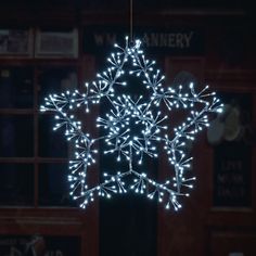 a lighted snowflake hanging from the ceiling