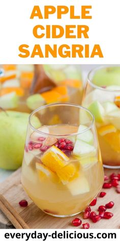 an apple cider sangria is garnished with pomegranate and orange slices