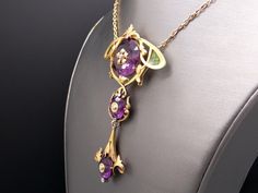 Jewelry Type: Plique A Jour Necklace ( Excllent Condition) Metal: 14k Yellow Gold Measurements: 3 3/4 inches x 2 inches (center section) 20 inch (length of chain) Markings: None Weight: 41.7 grams Main Stone: 3 Round Amethyst Color: Purple Measurement: A) 22mm x 11mm 20cts approx B) 12mm x 7mm 3cts approx C) 12mm x 7mm 3cts approx Gem Weight: 26ct approx Accent Stones: 6 matching Round Rose Cut Diamonds Color: I Clarity: SI-1 Gem Weight: 0.06ct approx. #12383 Exquisite Amethyst Necklace For Formal Occasions, Yellow Gold Amethyst Necklace For Wedding, Formal Amethyst Briolette Jewelry, Exquisite Formal Amethyst Necklace, Formal Purple Pendant Necklace, Luxury Purple Jeweled Jewelry, Luxury Purple Jewelry For Collectors, Collectible Gold Amethyst Jewelry, Exquisite Amethyst Jewelry In Yellow Gold