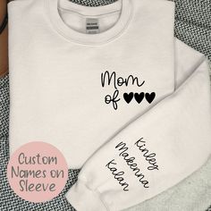 Custom Personalized Kids Name on Sleeve Sweatshirt for Mom Ideal for any situation, a unisex heavy blend crewneck sweatshirt is pure comfort. These garments are made from polyester and cotton. This combination helps designs come out looking fresh and beautiful. The collar is ribbed knit, so it retains its shape even after washing. There are no itchy side seams on these sweaters.  .: 50% cotton, 50% polyester .: Medium-heavy fabric (8.0 oz/yd² (271.25 g/m .: Loose fit .: Sewn-in label .: Runs tru White Crew Neck Hoodie For Mother's Day, Custom Text Crew Neck T-shirt For Fall, Crew Neck Cotton Hoodie For Mother's Day, Crew Neck Cotton Hoodie, Mother's Day Black Crew Neck Sweatshirt, Custom Text Long Sleeve Sweatshirt For Winter, Mother's Day Graphic Print Crew Neck Sweatshirt, Custom Text Cotton Sweatshirt For Streetwear, Casual Crew Neck Sweatshirt For Mother's Day