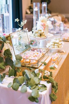 a table filled with desserts and flowers on top of it