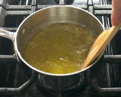 a person stirring something in a pot on the stove