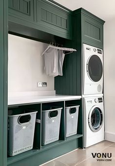 a washer and dryer in a green laundry room