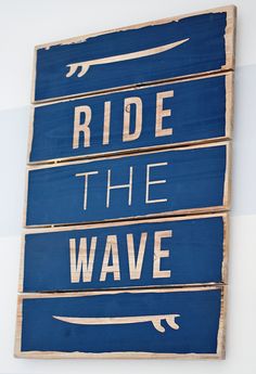 three wooden signs that say, ride the wave and ride the boat on blue boards