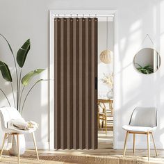 a living room with white walls and brown striped curtains