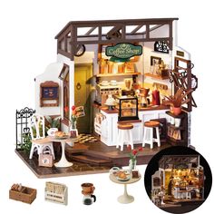 a doll house with furniture and accessories in the front, including an open kitchen area