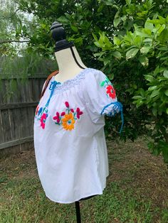 "Hand Embroidered Artisanal Blouse - Mexican Blouse - Fiesta Blouse - S/M This blouse had handcrafted details no other will have. It will fit a size small/medium Measurements: * 23\" long * 27\" wide Care * cloth wipe to clean * delicate care * hang dry Please email me your questions before buying. All of my items come from a smoke and pet free environment. I WILL BE PROCESS YOUR ORDER IN 1 DAY If you need the item expressed shipped please contact me to request it and the listing will be adjuste Traditional Spring Blouse With Machine Embroidery, Folk Style Short Sleeve Peasant Top With Embroidered Border, Folk Style Peasant Top With Embroidered Border, Artisan Embroidered Tops For Summer, Peasant Top With Multicolor Embroidery, Artisan Embroidered Summer Top, Peasant Blouse With Embroidered Border For Festivals, Traditional Spring Peasant Top With Yoke, Traditional White Festival Blouse