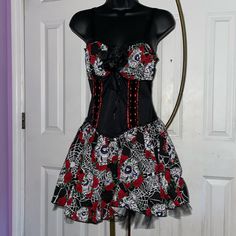 Love This “Day Of The Dead Sugar Skull ” Goth Punk Princess Dress. Vibrant Red, Black And White Graphics. Pictures Do Not Fully Capture The Beauty. . The Bodice Is Super Stretchy Which Makes It Super Comfy- The Look Of A Corset With The Forgiving Comfort Of Spandex. Silhouette Enhances Figure. Add Makeup And Skeleton Gloves And You Have An Awesome Halloween Get Up. Features: -Sugar Skull Day Of The Dead Face Graphics With Roses And Spider Webs -Mini Dress With Attached Tulle Petticoat -Black Ros Sugar Skull Dress, Skeleton Gloves, Black And White Graphics, Tulle Petticoat, Skull Day Of The Dead, Hot Topic Dresses, Skull Dress, Punk Princess, Spider Webs