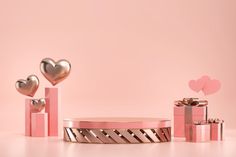 pink and gold valentine's day gifts with heart shaped boxes in the middle, on a light pink background