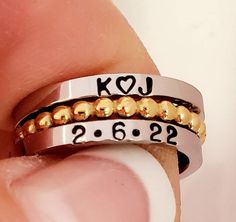 New! 3 pc name ring set. Choice of a gold or stainless steel 2 mm wide bubble spacer. The name rings are a petite 2 mm wide. Add names, dates, initials and emojis. Make sure to tell me which spacer you want the gold or silver. I hand stamp each letter then paint inside stamping, clean and polish. If you prefer no paint in stamping leave note. When ordering stacking rings you need to go up a 1/2 size. For example if you normally wear a 6.5 order the bubble spacer in a 7 and name rings in a 6.5. I Customized Adjustable Silver Engraved Ring, Adjustable Stackable Rings With Custom Name For Anniversary, Personalized Adjustable Stackable Rings For Anniversary, Customized Silver Engraved Ring With Adjustable Fit, Customizable Stackable Rings As Gift, Customized Adjustable Engraved Ring, Customizable Adjustable Stackable Rings As Gift, Custom Name Adjustable Stackable Rings For Anniversary, Customized Adjustable Engraved Promise Ring