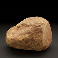 a large rock sitting on top of a black surface